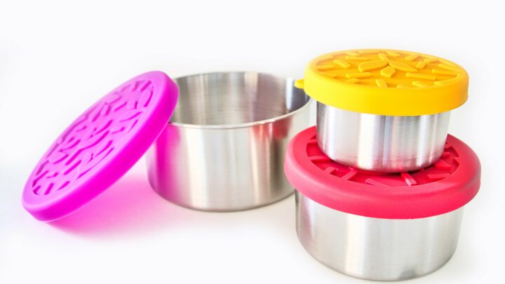 three stainless steel bowls with brightly colored silicone lids