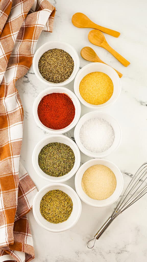 Turkey Rub supplies on a white marble background with a orange plaid towel