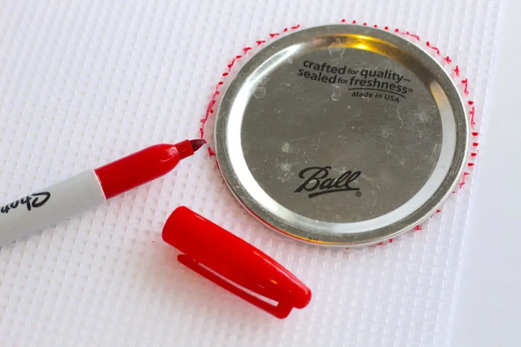 Sprout Lentils Lid Step 1 with a red marker is next to a bottle cap.