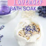 A cloth bag containing an oat bath soak with oatmeal and lavender rests on a white surface. Nearby, dried lavender sprigs accompany a small bowl holding a purple item. Text reads, 